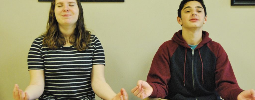 Meditating is an excellent stress-reliever, and it can be done anywhere! Mirra Goldenberg and Ethan Herman are pictured here meditating in the HBHA hallway. Photo by Sara Saidel.