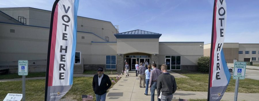 People wait to cast their ballot on the first day of early voting at an advance polling location Saturday, Oct. 17, 2020, in Overland Park, Kan. (AP Photo/Charlie Riedel)