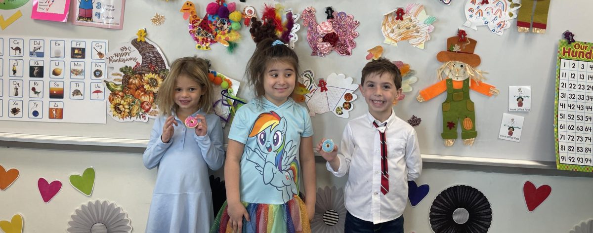 HBHA Kindergarteners posing in front of handmade turkey crafts