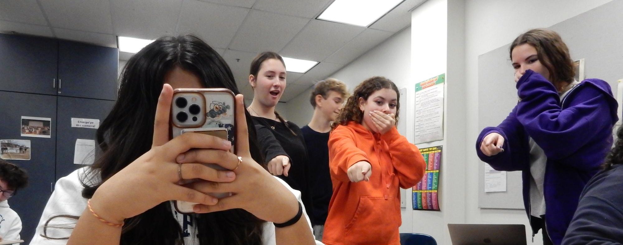 Students gasping at a girl who’s elbows are uncovered