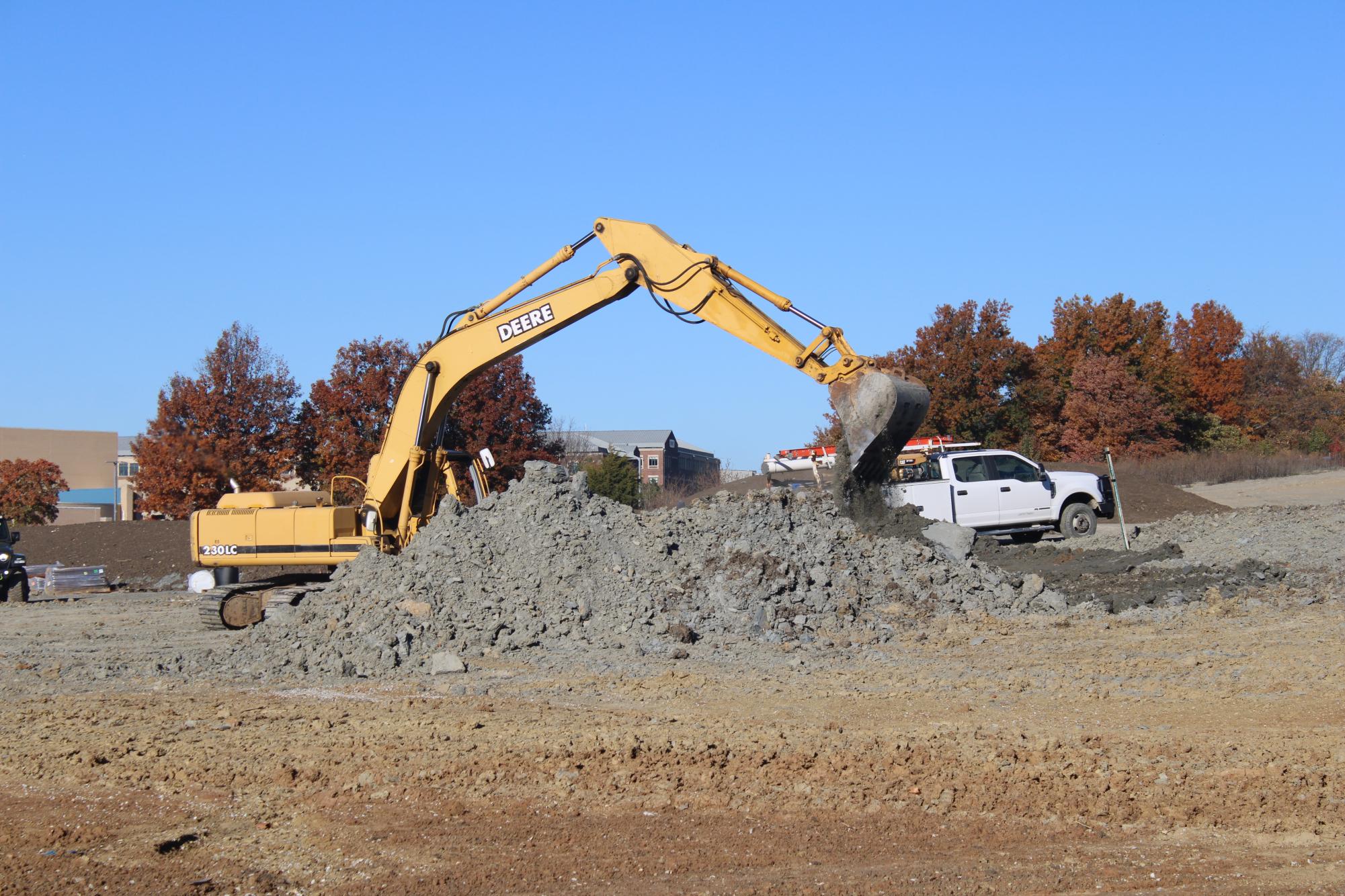 Excavator dumping dirt. Image by Skyler Penner. 
