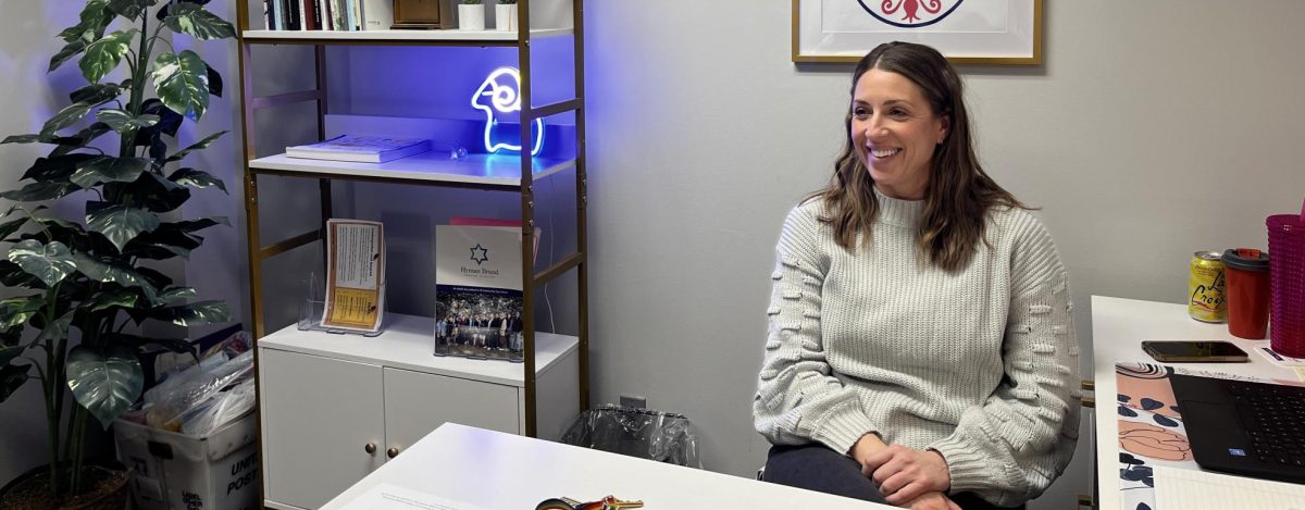 Bekah Zitron smiles while she meets with her co-worker to plan an event.