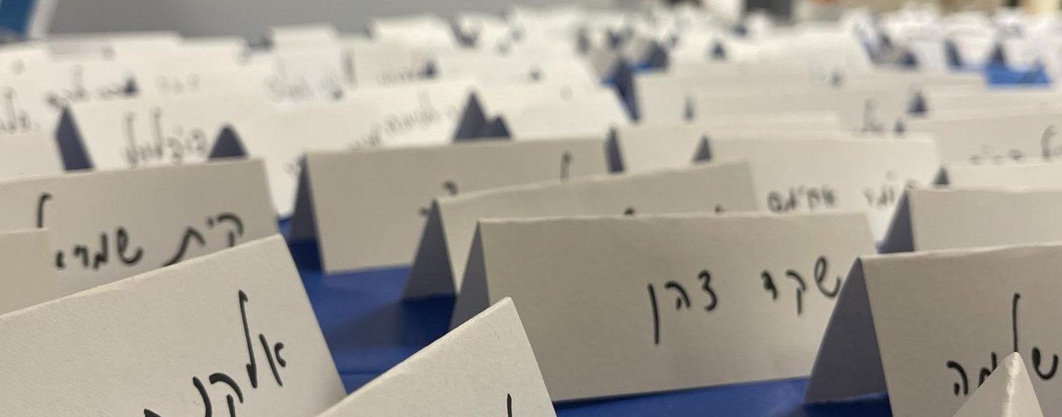 Names of Israeli hostages on a public table in the high school hallway.