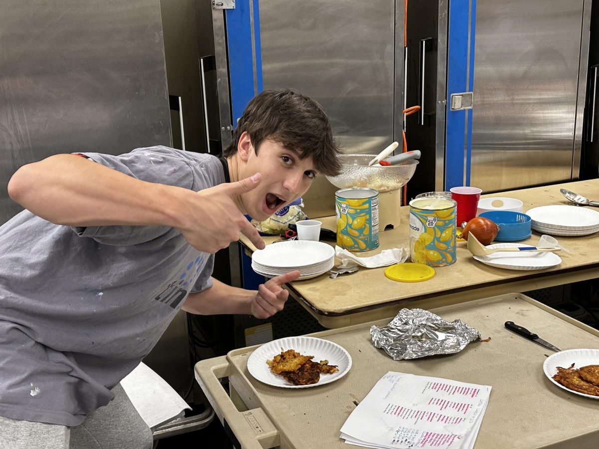 STUCO president Simon Balanoff cooking latkes for a HBHA lunch. Image by Noah Bergh 