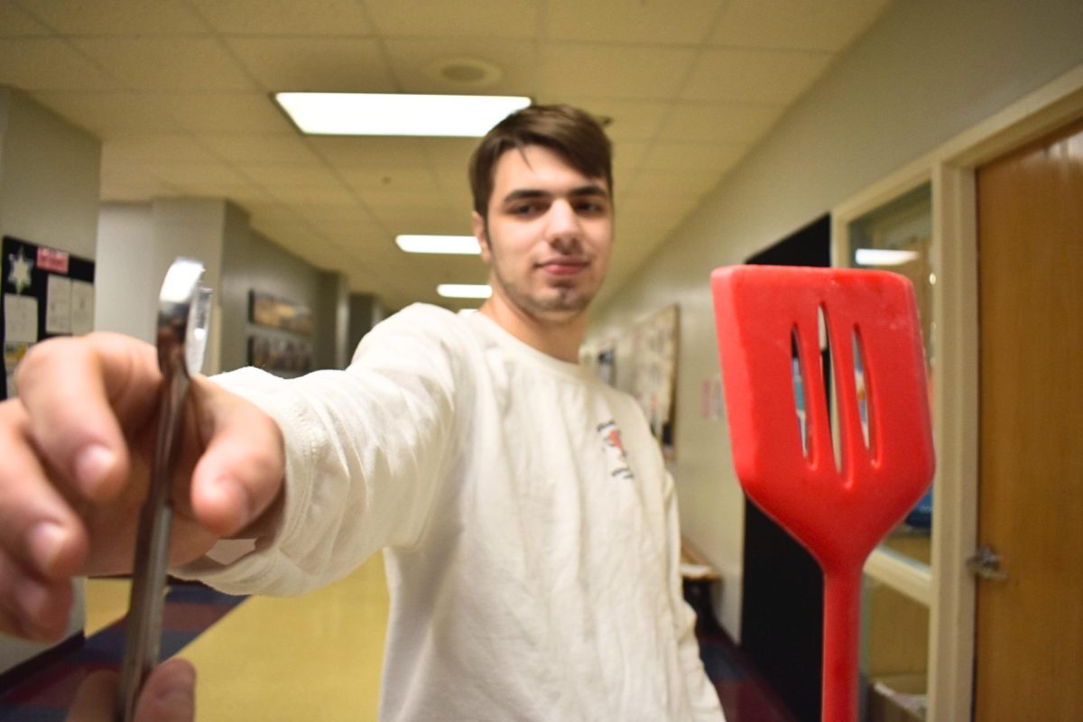 Depiction of a male who is influenced by toxic masculinity values choosing between two options, each representing the two genders. The tool is meant to show masculinity, which is why the male in the photo is choosing it. The spatula is meant to display femininity, as cooking is seen to be a woman’s job and role in relationships. 