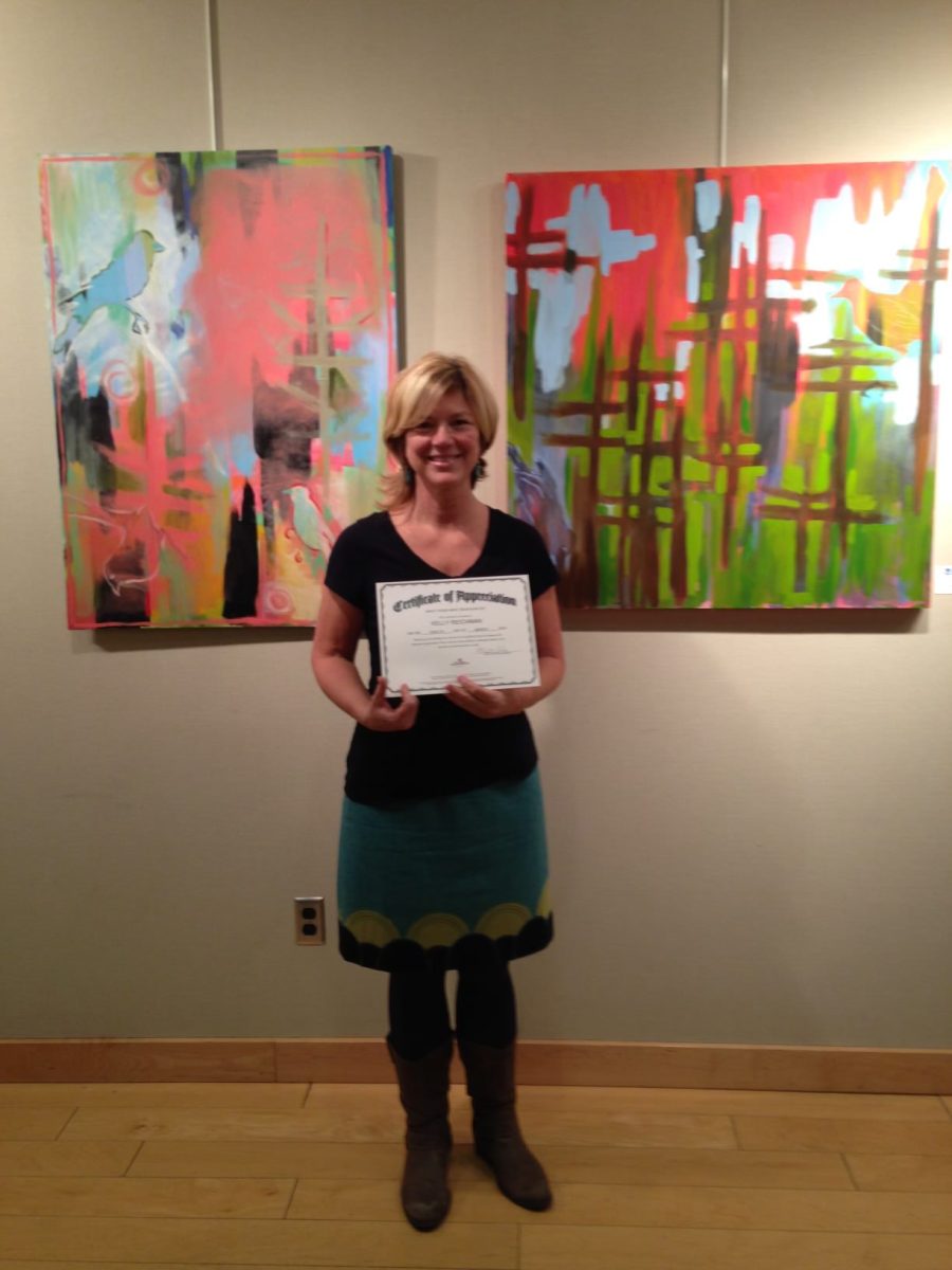 Reichman posing with an art certificate.