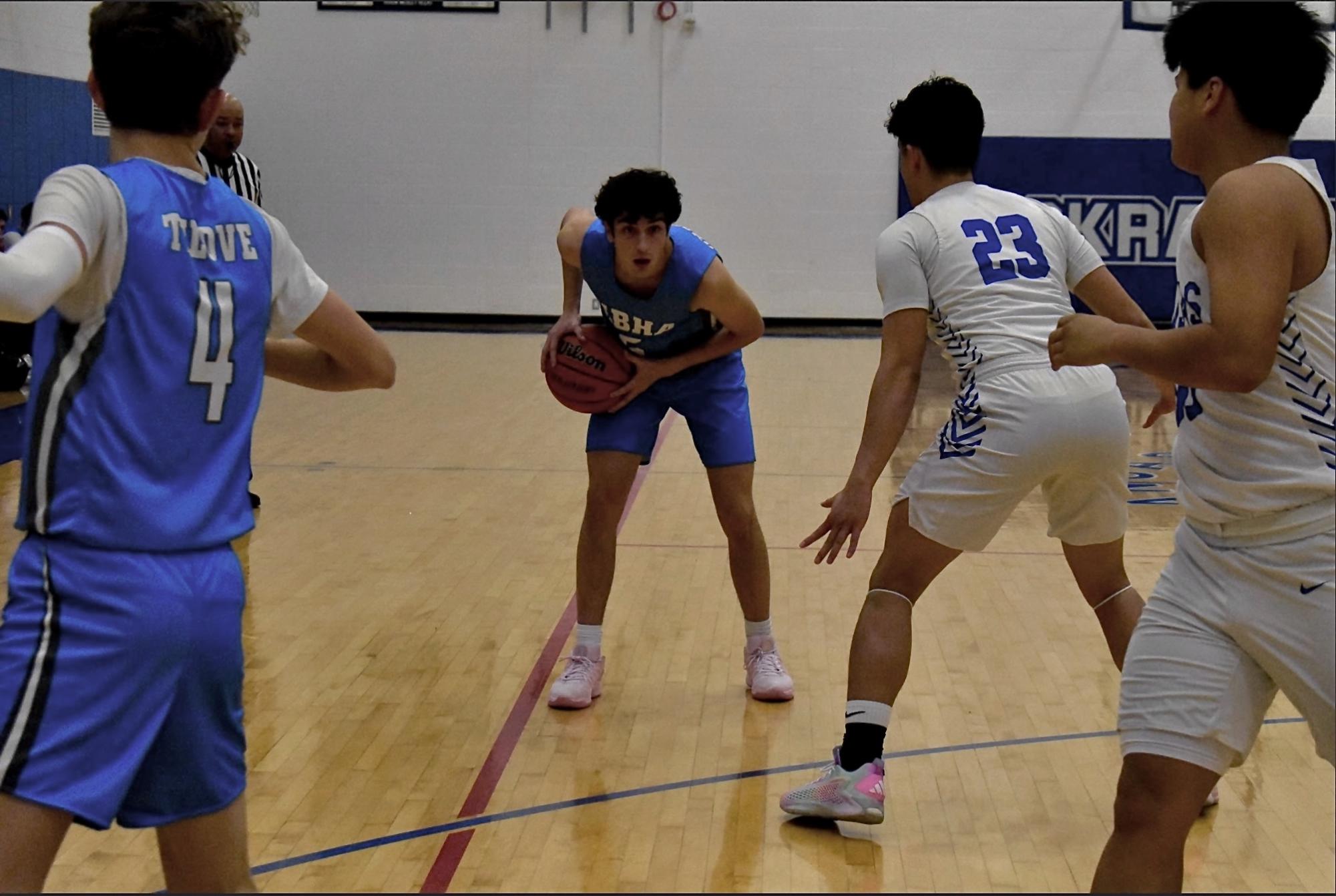 Senior David Wasserman is ready to attack the opposing defenders and make a play in a game of basketball against The Kansas School of the Deaf. Image taken by Avital Mullokandova
