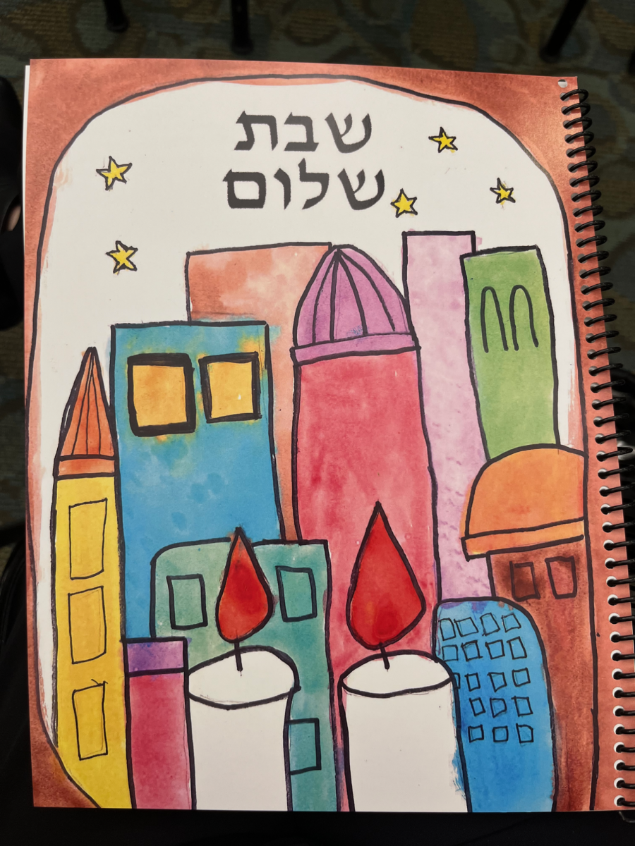 This week, Village Shalom, Overland Park, Kan.,  unveiled the cover art for their new Siddurim, donated by Sharon and Stuart Pace and Rachel and David Sosland in honor of Samuel and Gertrude Epstein. HBHA held a contest to select the cover art, and Madeline Sokol (8th grade) won with her vibrant painting, depicting Jerusalem. Art by Madeline Sokol. Photo provided by Eva Sokol. 