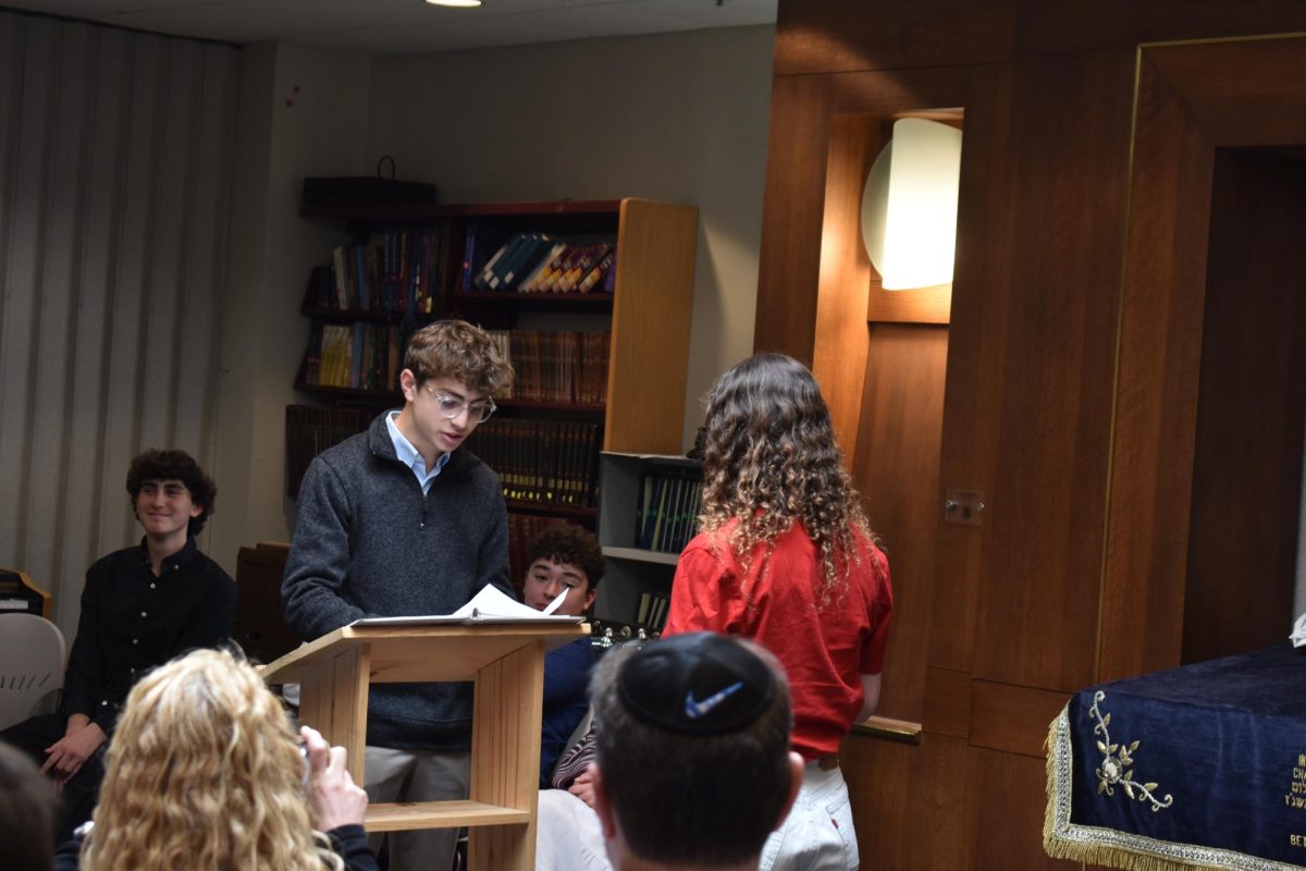 Jake Sosland, a sophomore, gives a heartfelt, emotional senior send-off speech to his sister Gabby. Photo by 